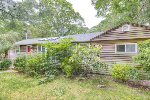 a wooden house with a garden in front of it at 509 Massive 3 bedroom with gorgeous pool in Hampton Bays