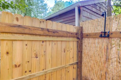 a wooden fence with a house behind it at 509 Massive 3 bedroom with gorgeous pool in Hampton Bays