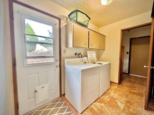 a kitchen with a washer and dryer next to a door at NEW - Peakview Lodge - Fireplace- Views in Prescott