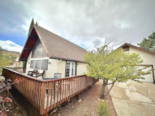 a house with a wooden deck with a tree at NEW - Peakview Lodge - Fireplace- Views in Prescott