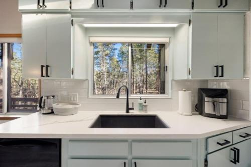 a white kitchen with a sink and a window at Morning Bliss Multi Family and Couples in Prescott