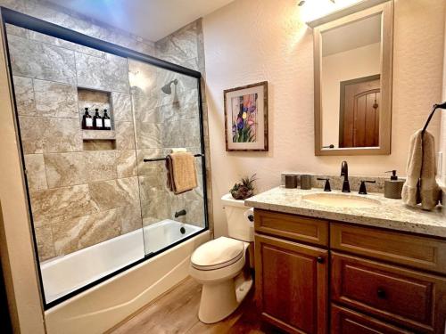 a bathroom with a shower and a toilet and a sink at Villa Hermosa- Guest Quarters in Prescott