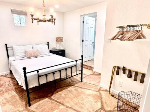 a bedroom with a bed and a chandelier at 1900 Suite Downtown Views pet friendly in Prescott