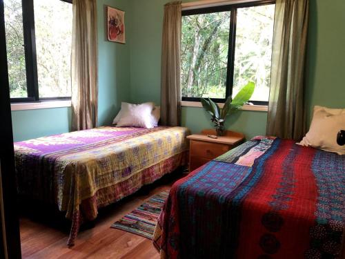 a bedroom with two beds and a window at Stunning Jungle Refuge Close to Town in Bullet Tree Falls
