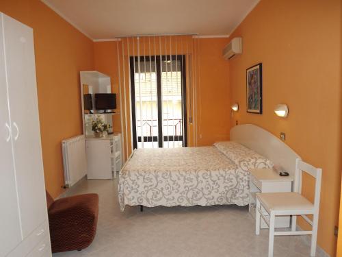 1 dormitorio con cama y ventana en Hotel Cristina en Chianciano Terme