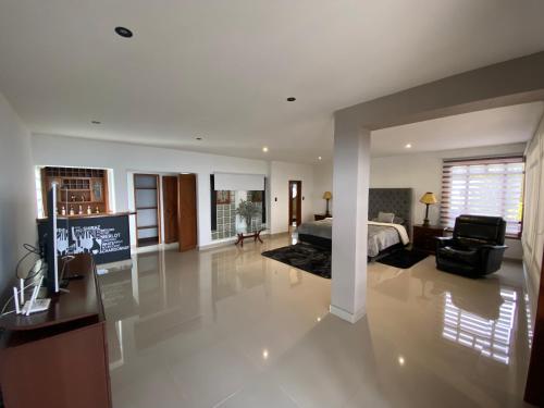 a large living room with a bed and a television at Villa Fátima dapa in Yumbo