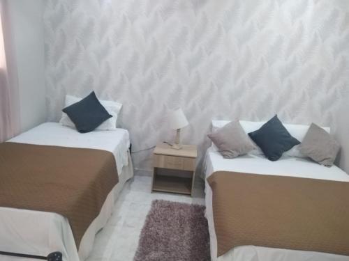 Кровать или кровати в номере Gran Hotel Valvanera Girardot