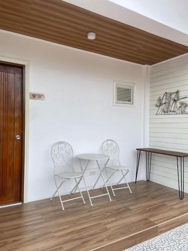 a dining room with two chairs and a table at Casa De Española Hotel and Resort in Aritao
