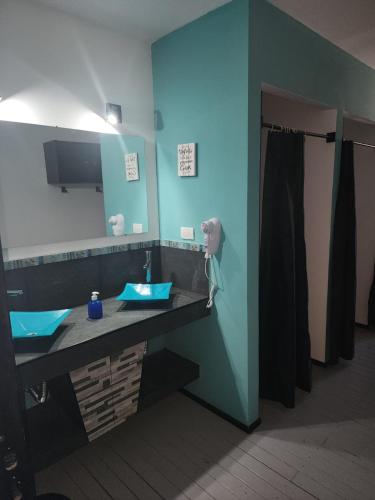 a bathroom with a sink and a mirror at Complejo Los Cipreses in Villa Carlos Paz