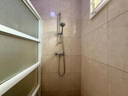 a bathroom with a shower with a shower head at 2 Slaapkamer Appartement in Paramaribo-Noord in Paramaribo