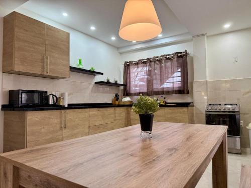 a kitchen with a wooden table with a vase on it at 2 Slaapkamer Appartement in Paramaribo-Noord in Paramaribo