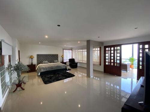 a large bedroom with a bed and a living room at Villa Fátima dapa in Yumbo