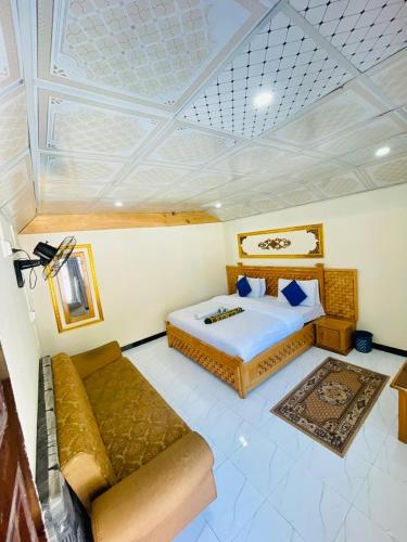a bedroom with a bed and a couch in a room at Ibex Riverside Cottage Neelum Valley in Kundālshai