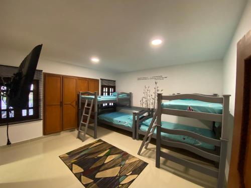 a room with two bunk beds and a flat screen tv at Villa Fátima dapa in Yumbo