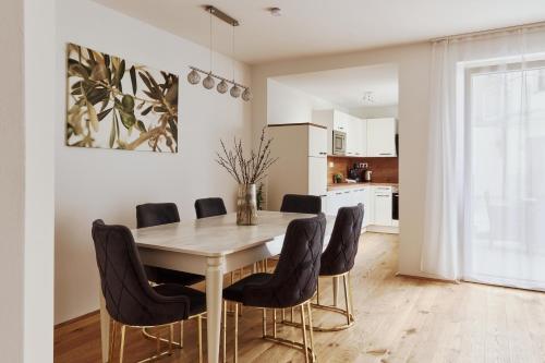 a dining room with a table and chairs at Symphony Apartments Vienna - Garden, Terrace and Grill in Vienna