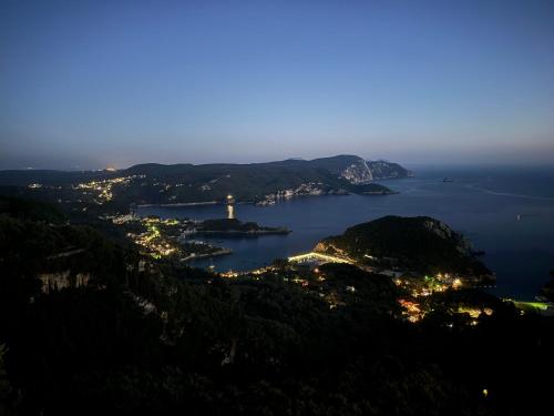 a view of a bay at night at Carmen's 1st floor Apartment with floor Sea View and roof terrace- Lakones in Lákones