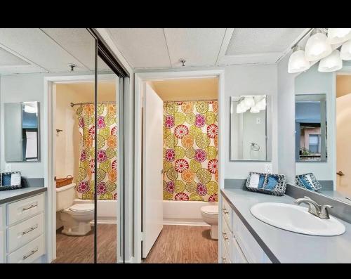 a bathroom with a sink and a toilet and a shower at Stylish Hollywood Hideaway 1Bed Rooftop Pool with Iconic View D in Los Angeles
