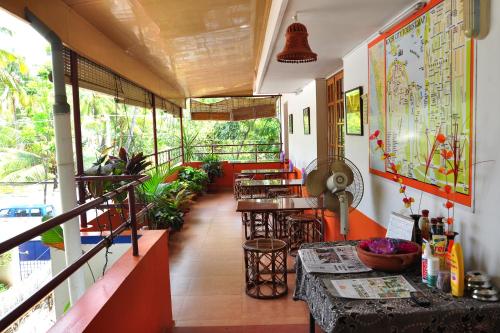 a restaurant with tables and chairs in a room at Sajhome Fortkochi, Kochi, Kerala, inda in Cochin
