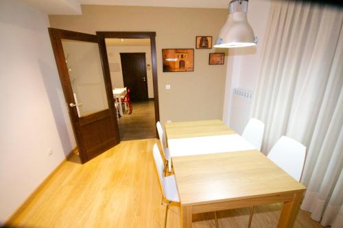 a dining room with a table and a table and chairs at La Casa de las Aldeas in Daroca
