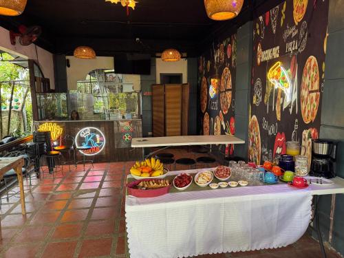 a table with food on it in a restaurant at BZ Hostel Cebu in Lapu Lapu City