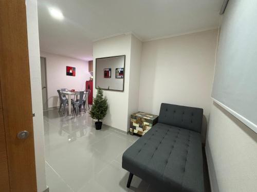 a living room with a couch and a dining room at A pasos del metro Steps away from the subway in Santiago