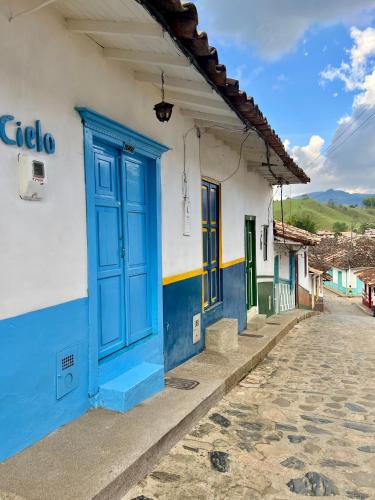 a building with a blue door on a street at Casa Cielo in Concepción