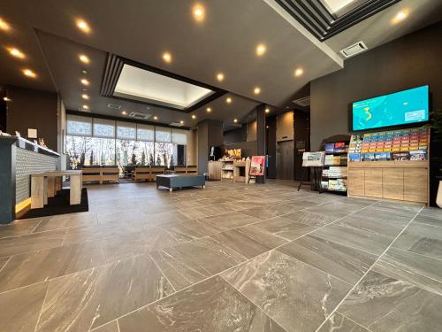 a store with a large tile floor in a store at Hotel Route Inn Okayama Maniwa in Maniwa