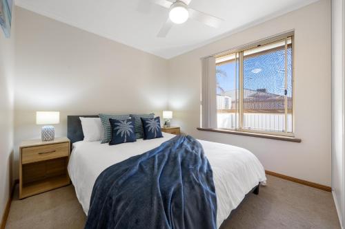a bedroom with a large bed and a window at Moana Hideaway - 3BR, BBQ, Parking in Moana