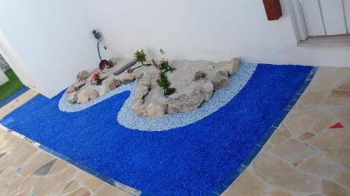 a blue rug on the floor in a room at Villa Fina Aruba in Palm-Eagle Beach