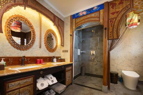 a bathroom with a sink and a shower at Datong Yunzhong Traditional Courtyard in Datong