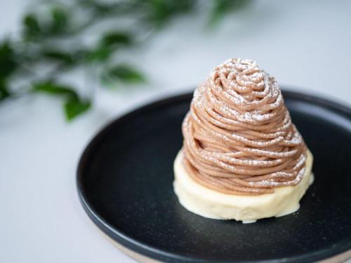 a chocolatecovered dessert on a black plate at the square hotel KANAZAWA in Kanazawa