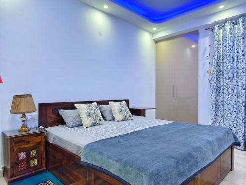 a bedroom with a bed with a blue ceiling at Divisha Homes-1BHK Luxury Apartment in South Delhi in New Delhi