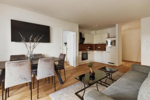 a living room with a table and a couch at Symphony Apartments Vienna - Garden, Terrace and Grill in Vienna