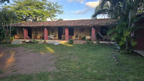 a house with a yard in front of it at Palmerola Inn in Villa de San Antonio