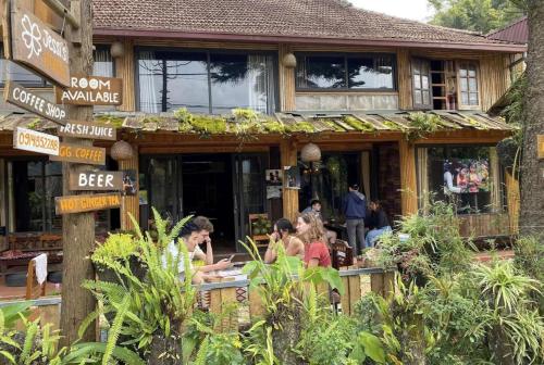 a group of people sitting outside of a restaurant at Mộc Nhiên Homestay in Sa Pa