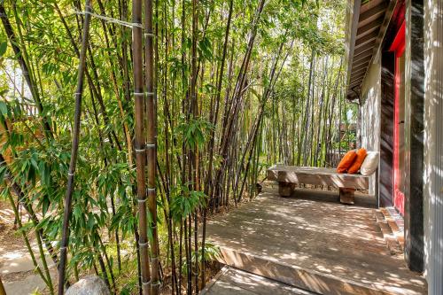 a bench sitting on a porch in a bamboo forest at Urban Oasis next to Santana Row in San Jose