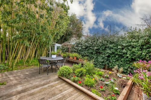 a wooden deck with a table and some plants at Urban Oasis next to Santana Row in San Jose