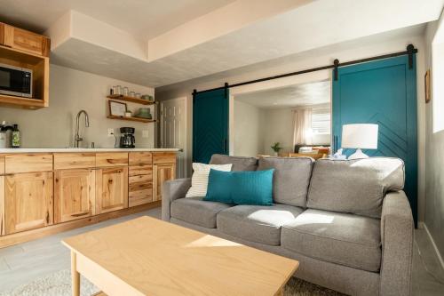 a living room with a couch and a kitchen at Cozy Getaway - Perfect Base for Exploring Colorado Springs in Colorado Springs
