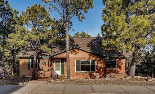 a brick house with trees in front of it at Cozy Getaway - Perfect Base for Exploring Colorado Springs in Colorado Springs