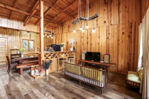 a living room with wooden walls and wooden floors at Khai Quynh Villa 3 - Venuestay in Khu Chi Lăng