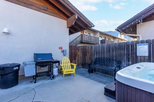 a patio with a desk and a yellow chair at Snowcreek Suite - Aspen - Hot Tub - Kitchenette in Leavenworth