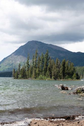 a body of water with trees and a mountain at Snowcreek Suite - Aspen - Hot Tub - Kitchenette in Leavenworth