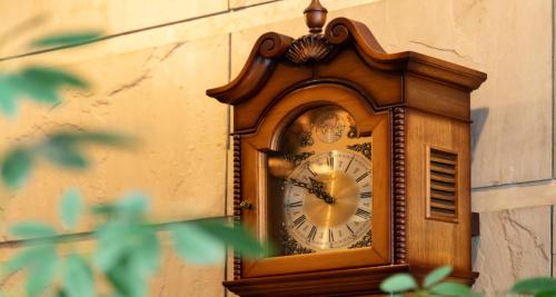 a wooden clock on the side of a building at 桑名シティホテル in Kuwana