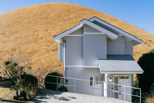 a house in front of a hill at COCO VILLA 大室山 -Izu Omuroyama- in Futo