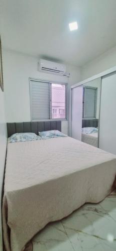 a bedroom with a large bed and two windows at Apartamento completo Fit Coqueiro 1 Cop 30 in Ananindeua