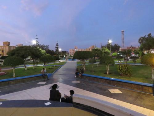 two people sitting in a park at night at Mamre Guest House Tacna - Hospedaje in Tacna