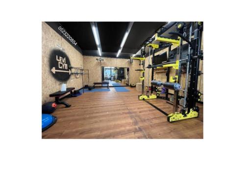 a gym with treadmills and equipment in a room at Levis in Chorazim