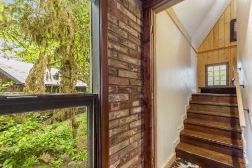 a staircase in a house with a window at Stilly River Haus - Hot tub - Firepit - Fireplace in Granite Falls