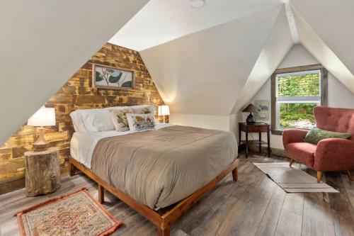 a bedroom with a bed with a stone wall at Stilly River Haus - Hot tub - Firepit - Fireplace in Granite Falls