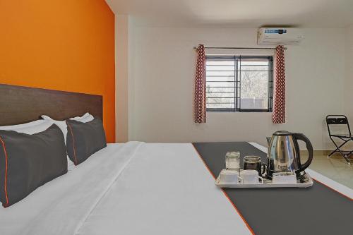 a bedroom with a bed with a blender on a table at The Blooms stay inn in Bengaluru